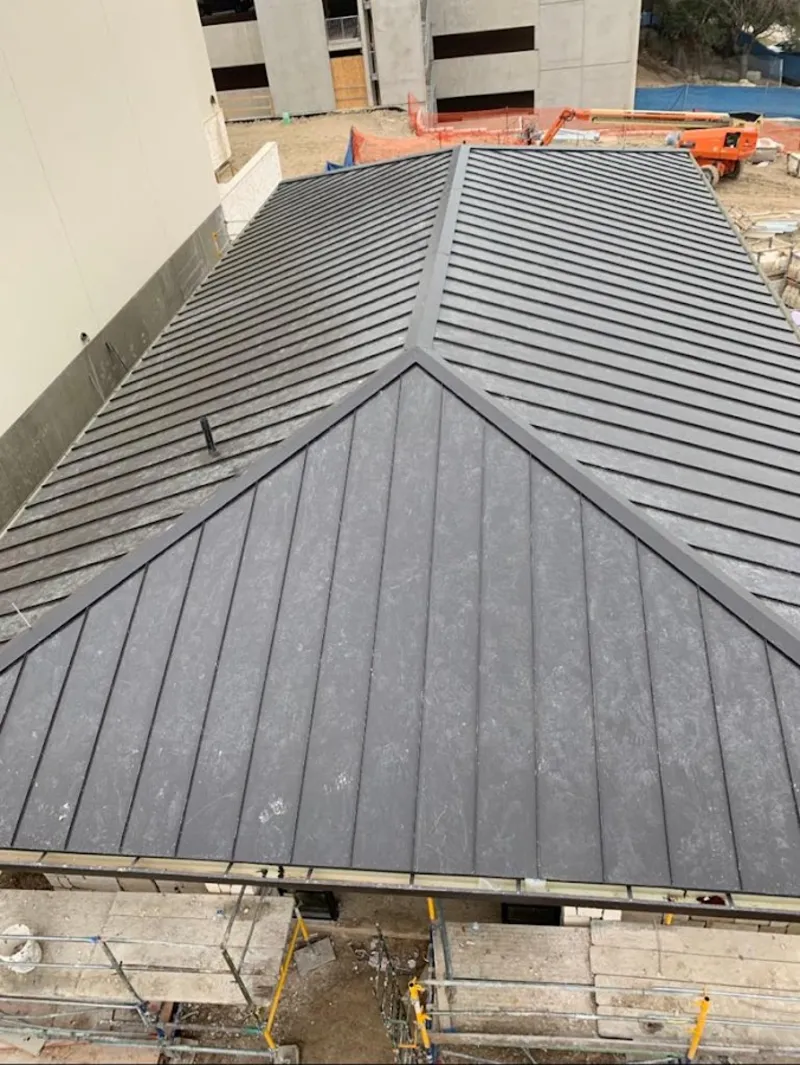 Commercial metal roof construction with crane equipment in Canonsburg